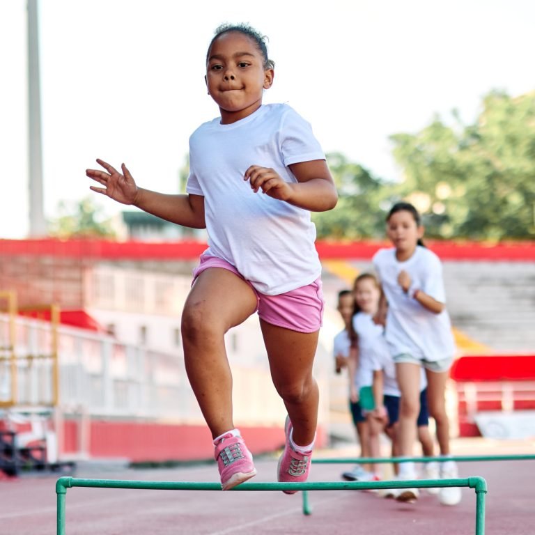 Young children having athletic exercise class running on the track, healthy lifestyle and children sport education concepts